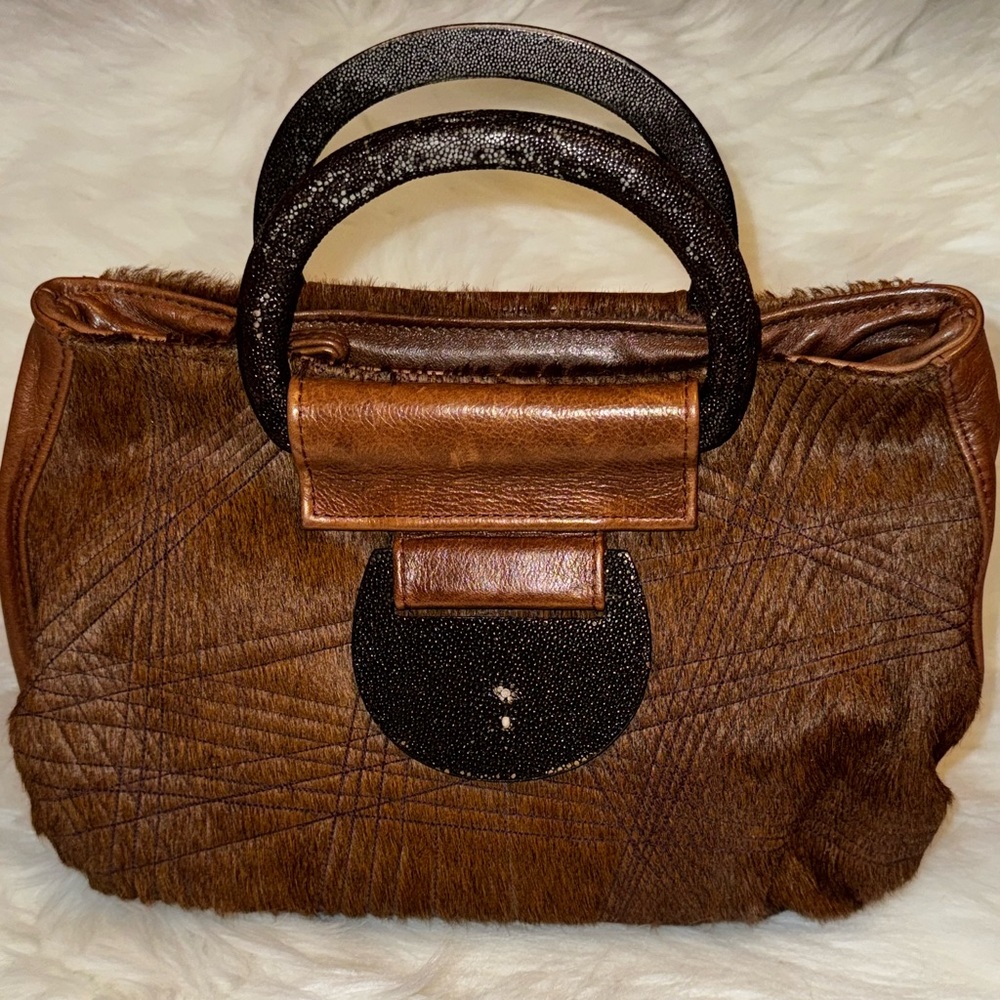 Brown Leather Handbag with Calf Hair and Textured Handles.